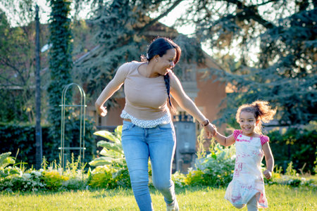 A hispanic woman with her children in the parkの写真素材
