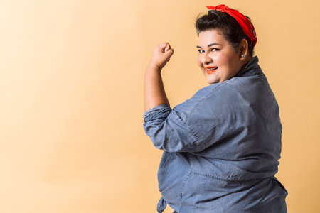 woman show her strength. hispanic adult female with bandana feminism concept.の写真素材