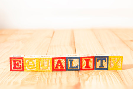 Spectacular wooden cubes with the word EQUALITY on a wooden surface.の写真素材
