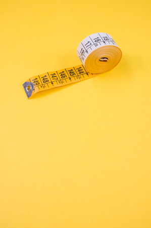 flexible meter roll isolated on a yellow color surface