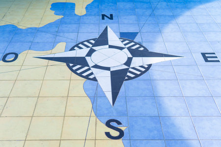 Compass wind rose with the cardinal points, north, south, east and west on the floorの写真素材