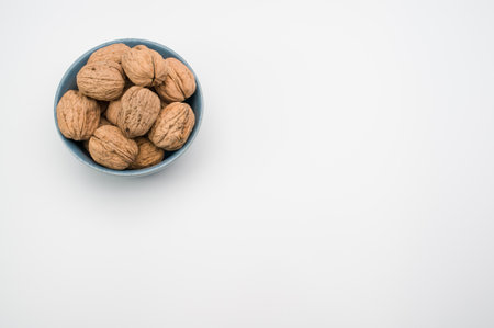 White bowl with Stack Walnuts isolated on a white background with free spaceの写真素材