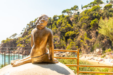 Mermaid sculpture in Cala Canyet next to the town of Tossa de Mar. Girona, Costa Brava in the Mediterraneanの写真素材