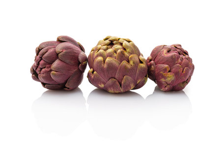Three artichokes vegetable white isolatedの写真素材