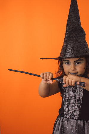Portrait of a little witch celebrating Halloweenの写真素材