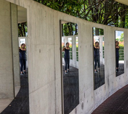 Golfer Practice in Driving Range Her Golf Swing and Mirror Image in Switzerland.の写真素材