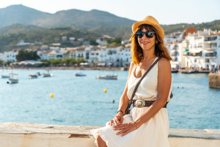 A young woman in a white dress in Cadaques by the sea, Costa Brava of Catalonia, Gerona, Mediterranean Sea. Spainの写真素材