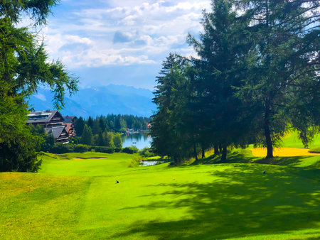 Golf Course Jack Nicklaus with Mountain View and Clouds in a Sunny Summer Day in Crans Montana, Valais in Switzerland.のeditorial素材