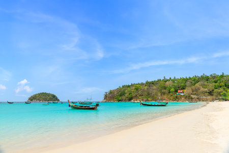 Kata Beach with crystal clear water and wooden traditional boat, famous tourist destination and resort area, Phuket, Thailandの写真素材