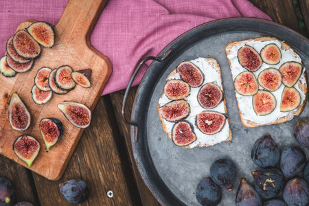 Top view of soft ricotta sandwich with ripe figs served on a tray.の写真素材