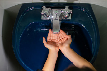 constant hand washing with plenty of soap and water to prevent the spread of covid 19の写真素材