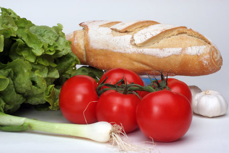 Composition with raw vegetables and breadの写真素材