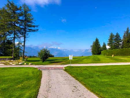Crans Sur Sierre Golf Course with Mountain View in Crans Montana in Valais, Switzerland.のeditorial素材