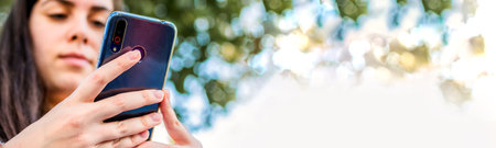 Close up of female hands holding a smart phone.