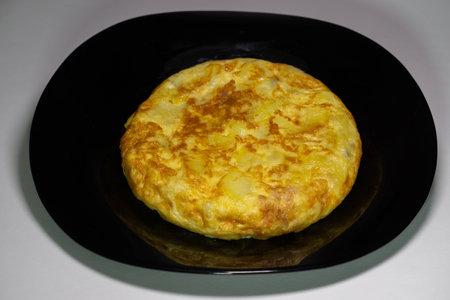 process of elaboration of potato omelette in spain in a frying panの写真素材