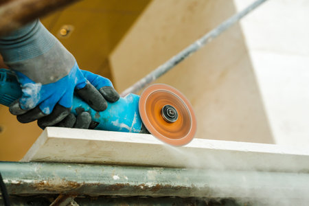hand holding mansionry machine to polish marble stone.
