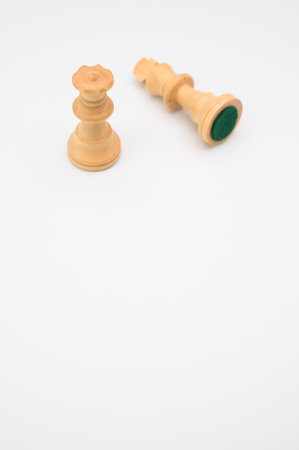A vertical shot of white chess pieces isolated on a white background with copy space