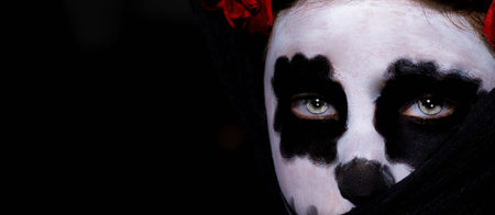 Closeup portrait of Calavera Catrina. Young woman with sugar skull makeup. Dia de los muertos. Day...