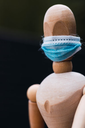 articulated wooden mannequin with blue maskの写真素材