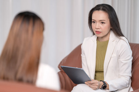 Asian professional psychologist doctor consults in psychotherapy session or counsel diagnosis health. Psychology and mental therapy concept conceptの素材