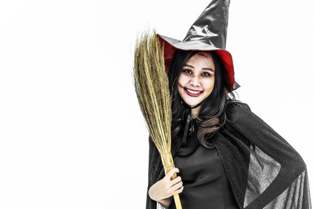 Halloween party Girl wearing witch costume with a hat, Celebrating. Beauty asian woman with long...