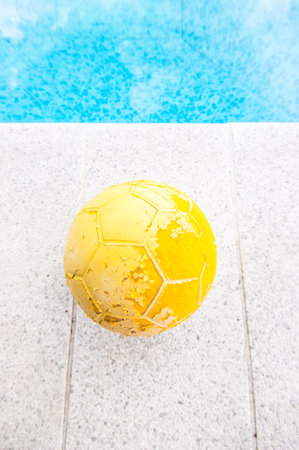 old yellow ball in a poolの写真素材