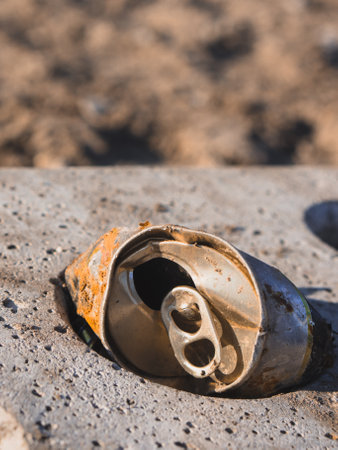 Old squeezed can with rust in soft focusの写真素材
