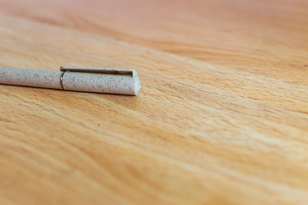 Close-up of Eco Friendly text on a recycled object on a wooden background.の写真素材