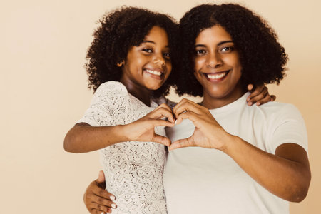 selective focus hands of mom and child making a heart.の写真素材