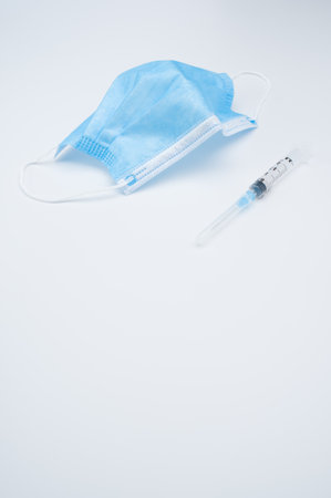 Isolated respiratory mask with syringe on a white background wit text spaceの写真素材
