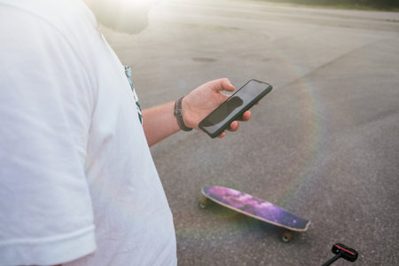 Young male youtuber filming himself for a video with a longboardの写真素材
