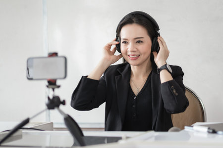 Stock photo of a Southeast Asian Ethnic business woman student teacher tutor video conference calling on laptop computer talk by webcam learn teach in online chat, distance webinar online teaching conceptの写真素材