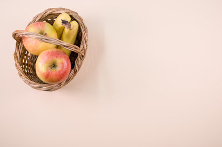Fresh and healthy fruits on beige surface - apples and bananas with text spaceの写真素材