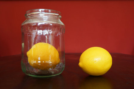 Two lemons and a jar of glassの写真素材