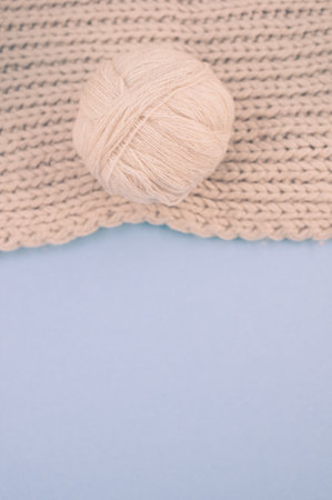 hand knitted soft wool on a cyan background with copy space