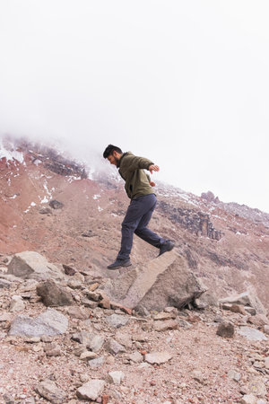 Adventure young man in the mountains, enjoying the fresh air and the mountains.の写真素材