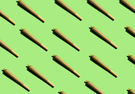Cannabis joint pattern on green background. Concept of medical cannabis, therapeutic cannabis,...