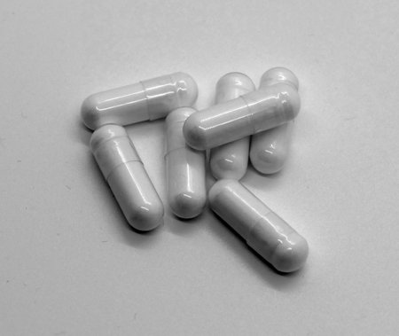 White capsules on white background photographed in a photo box
