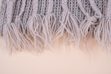 hand knitted soft wool cloth on a beige background with copy space