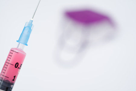 syringe and respiratory medical mask on a white background with text spaceの写真素材