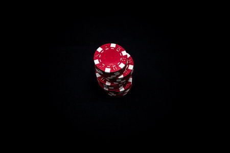 Stack of poker chips on black backgroundの写真素材