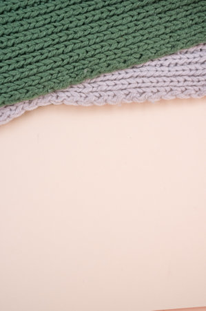 hand knitted soft wool cloth on a beige background with copy spaceの写真素材