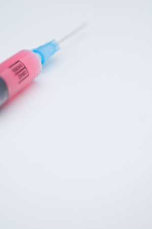 an isolated injection syringe on a white background with text spaceの写真素材