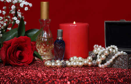 Candle and Red Rose With Perfume on Red Velvet Backgroundの写真素材