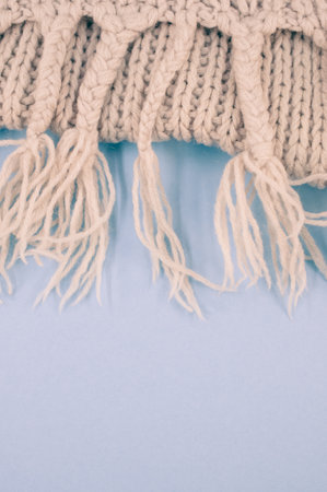 hand knitted soft wool on a cyan background with copy spaceの写真素材