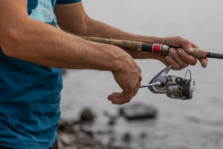 Close-up of a male fisherman holding his hinge
