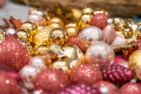 Golden and pink pink Christmas decorations lying aroundの写真素材