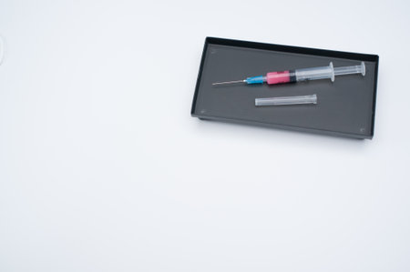 an isolated injection syringe in a box on a white background with text space