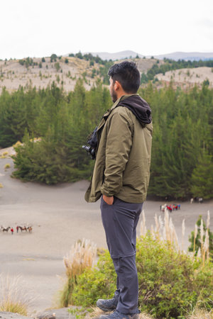 Young walking through the desert, enjoying the peace and silence of nature, away from the city.の写真素材