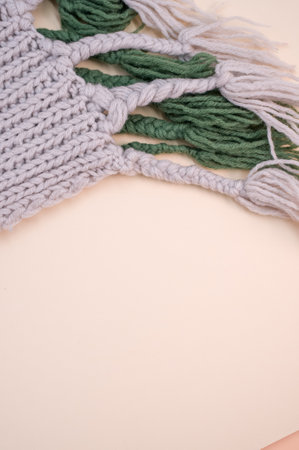 hand knitted soft wool cloth on a beige background with copy spaceの写真素材